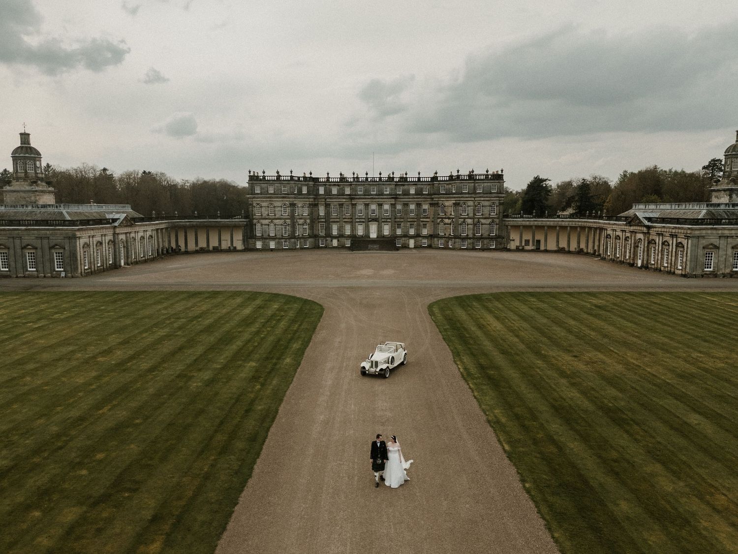 Aerial view of sprawling estate grounds with classic architecture and manicured lawns.