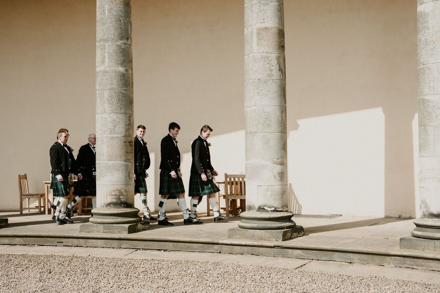 Classical colonnade with stone pillars creating an elegant architectural setting.