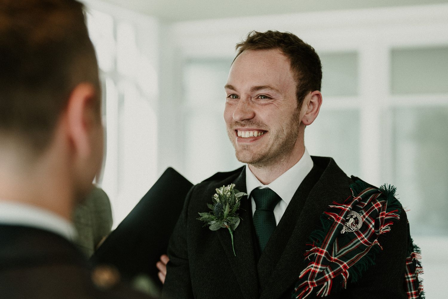 Wedding celebration in formal attire with traditional Scottish kilts.