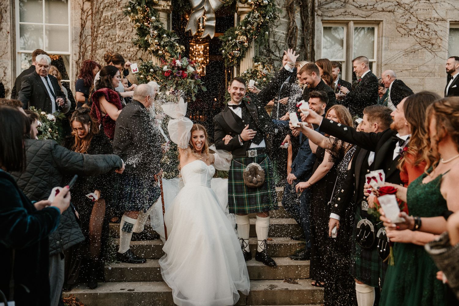 Celebratory moment with confetti outside historic building during wedding festivities.