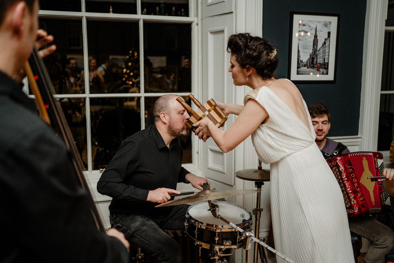 Indoor wedding celebration with musical entertainment and dancing.