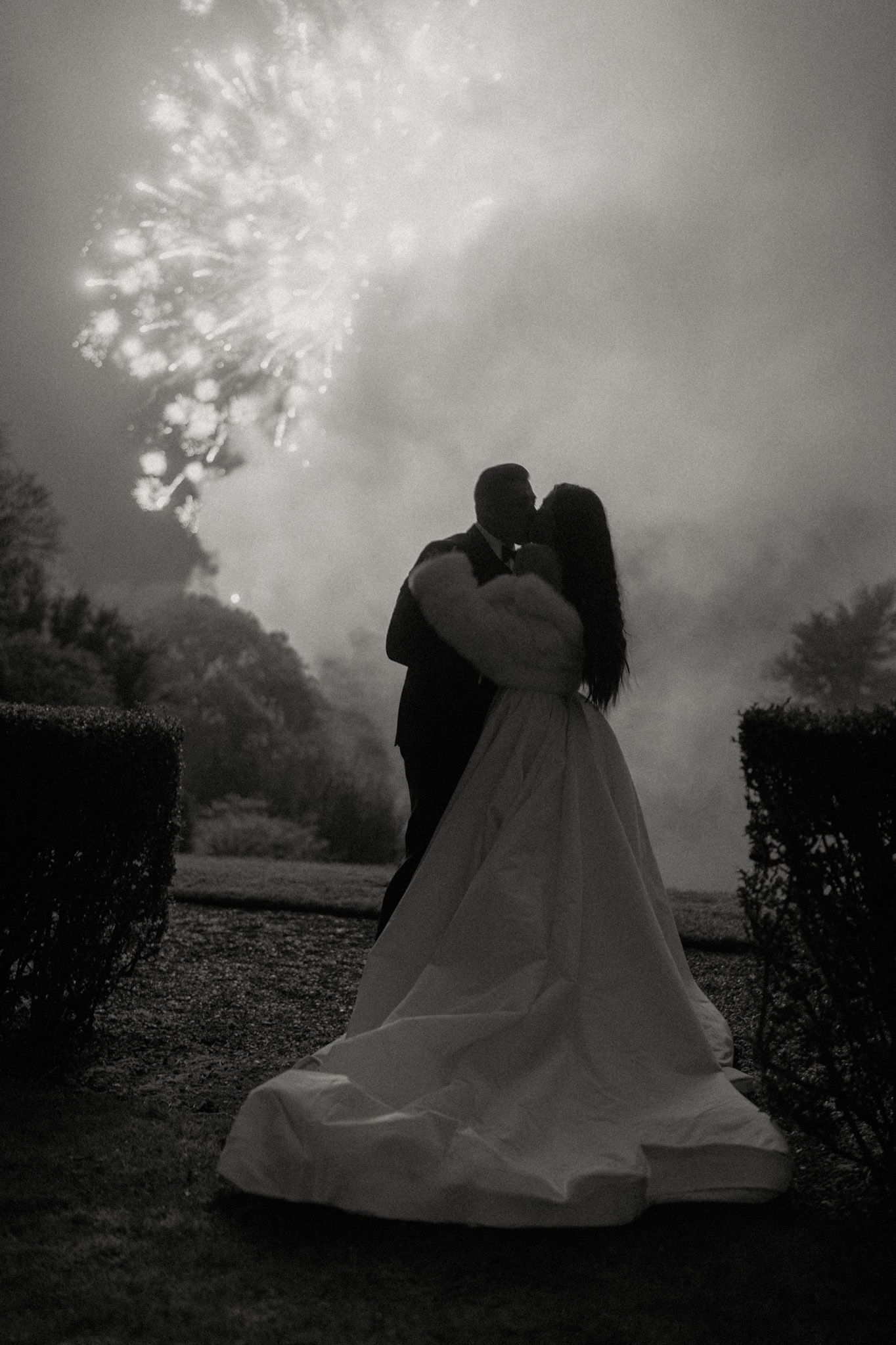 A moody black and white photo series showing a person in a flowing white dress moving through a misty outdoor setting.