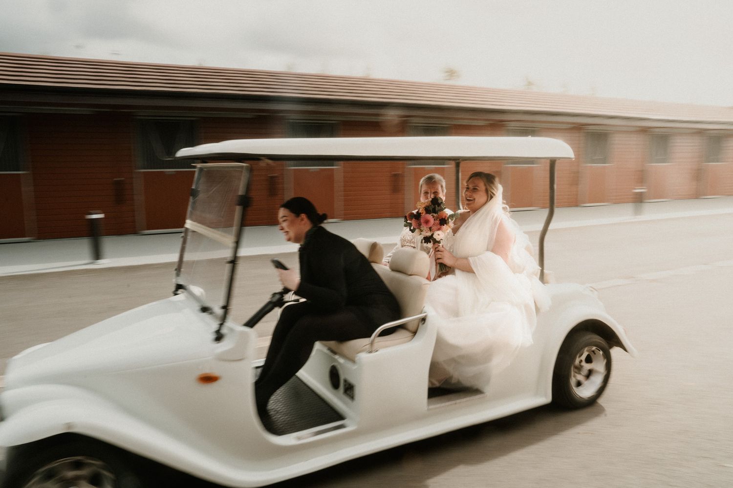 Classic white vintage wedding car transports couple on their special day.