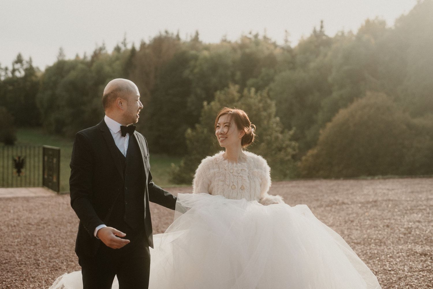 A couple shares an intimate moment during their first dance at sunset.