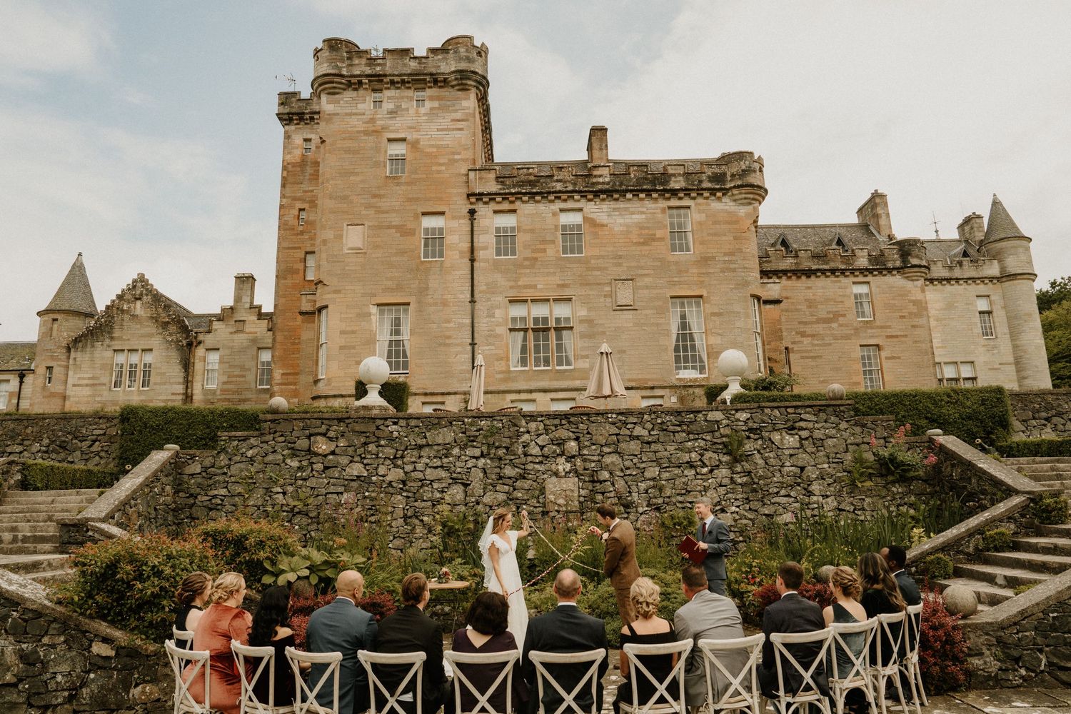 Majestic Scottish castle wedding venue with stone walls and grand staircase.