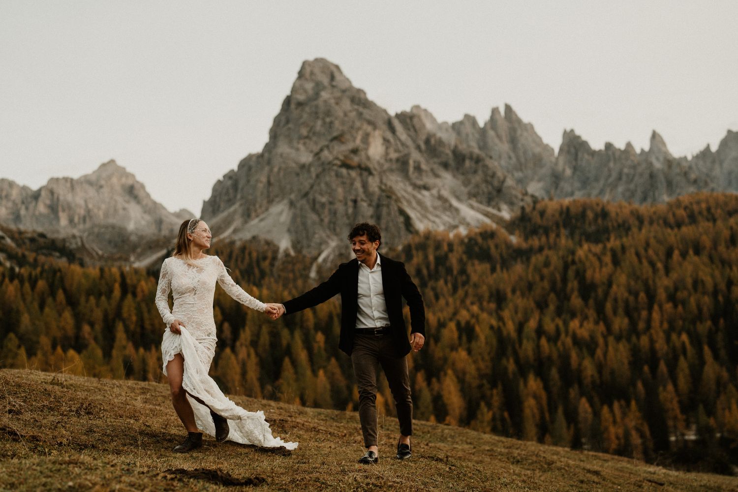 Dancing couple silhouetted against stunning mountain scenery and fall foliage.