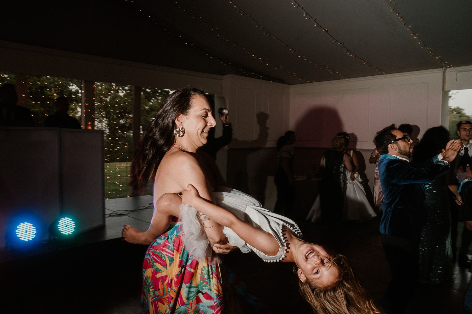 Energetic dance moves captured during a lively wedding reception party.