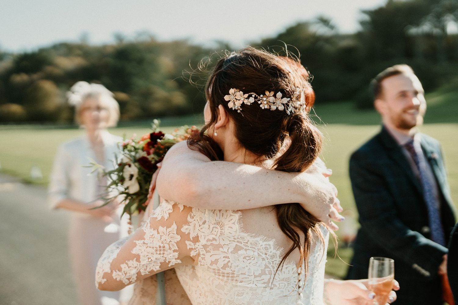 Candid emotional moment captured during outdoor wedding reception.