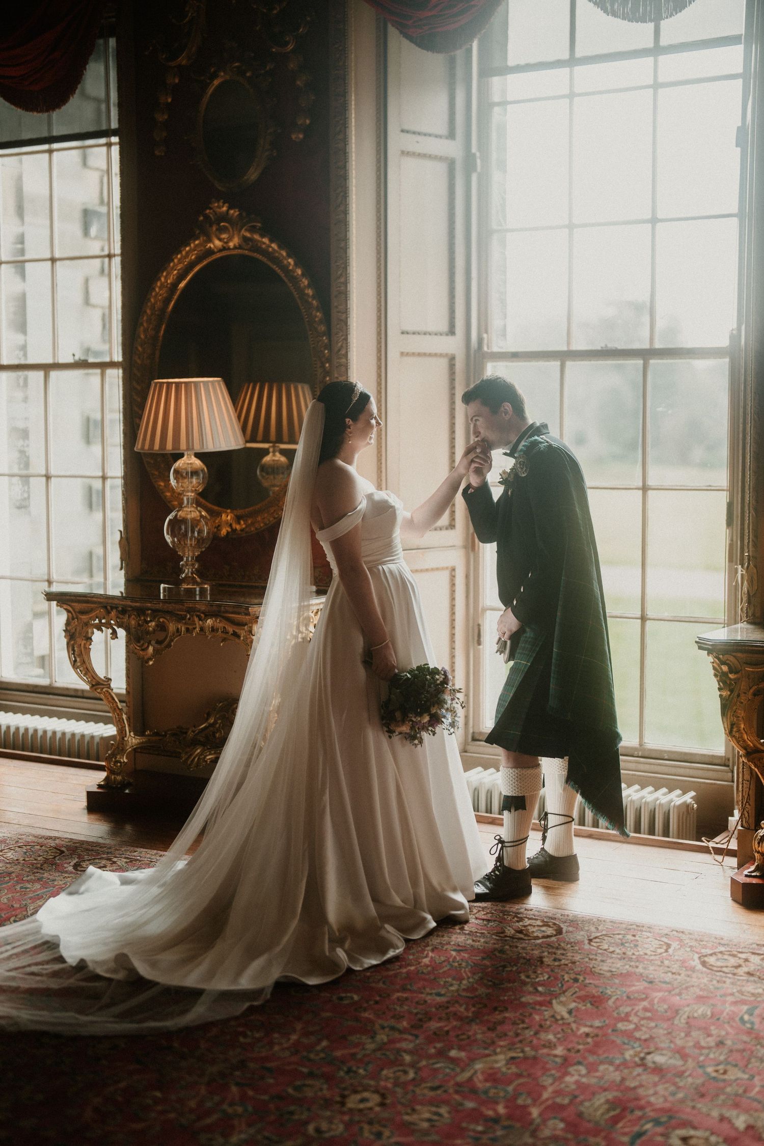 Romantic wedding moments captured in sunlit historic room with elegant decor.
