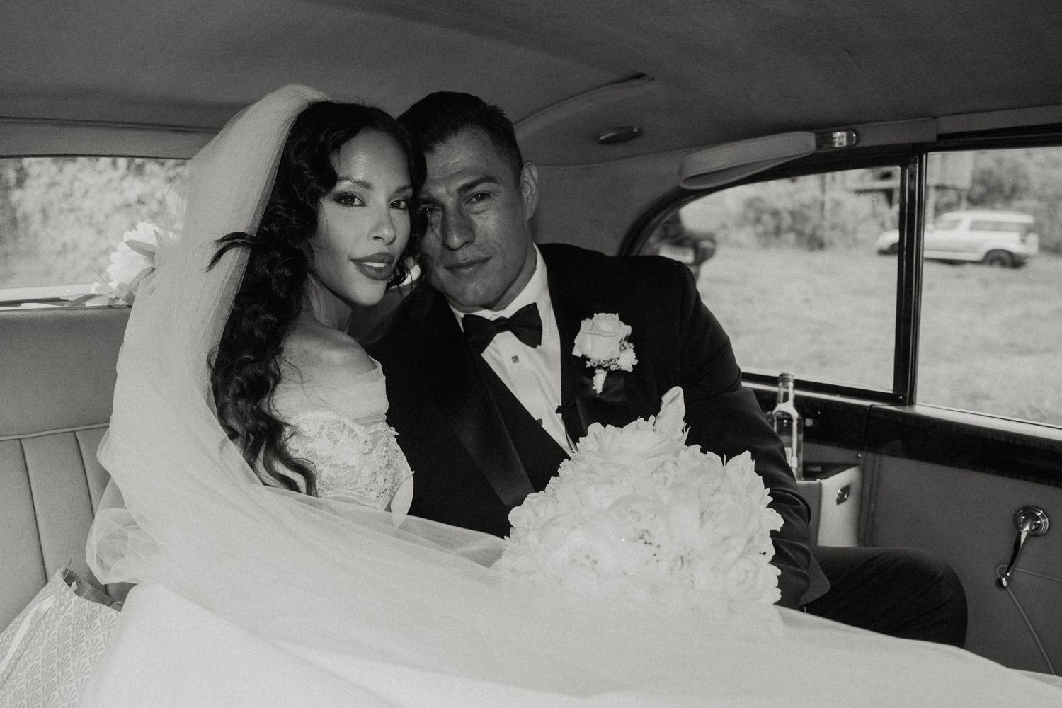 Black and white wedding portraits captured inside classic car.