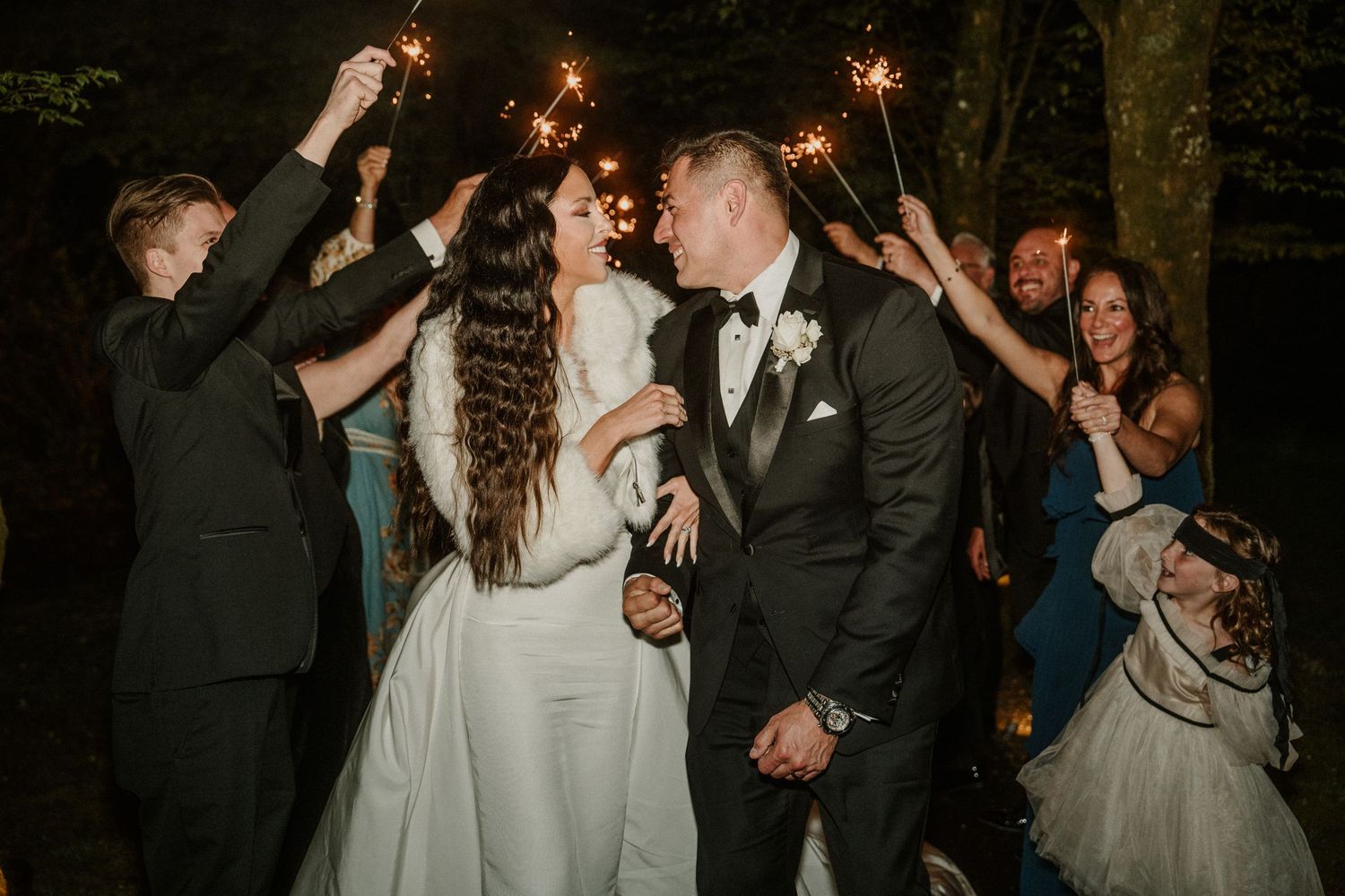 Wedding celebration with sparklers creating a magical nighttime moment.