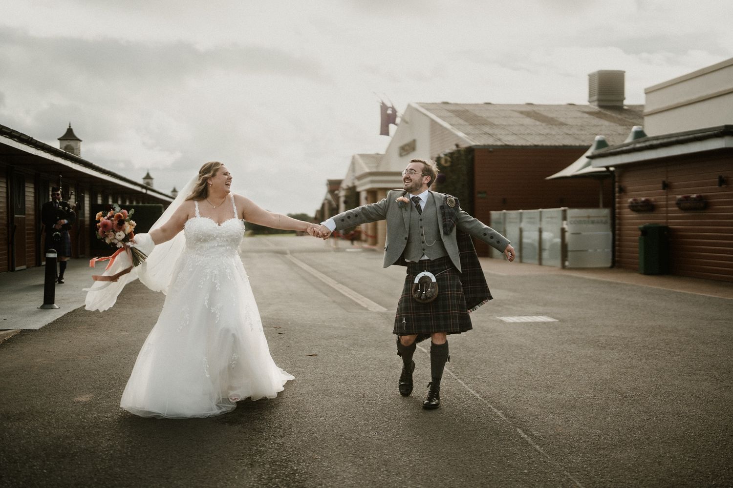 Artistic black and white panoramic of a wedding couple walking outdoors.