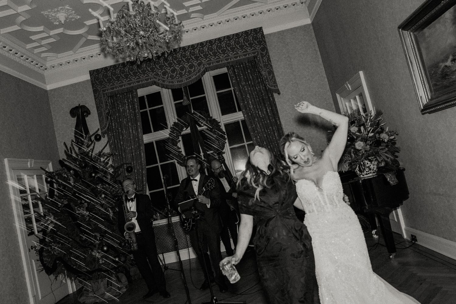 Wedding party dancing and celebrating during a joyful reception celebration.