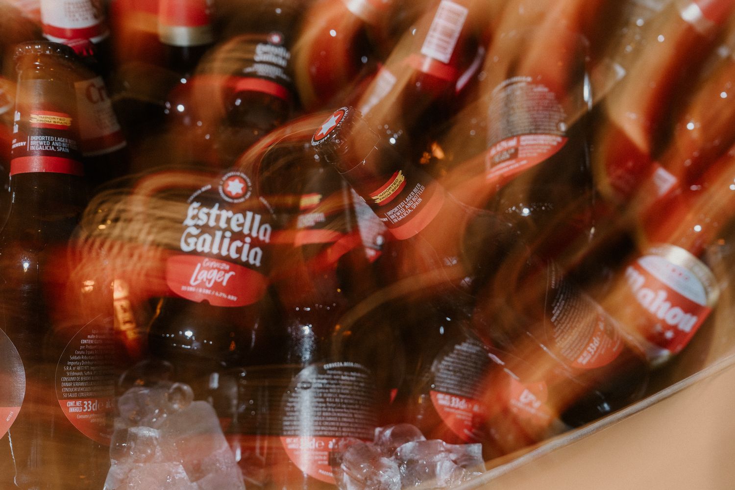 Blurred collection of red beer bottles creating an abstract party atmosphere.