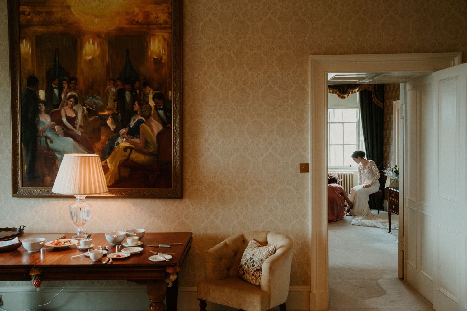 Elegant interior hallway with vintage furniture, ornate moldings, and warm lighting creates a luxurious ambiance.