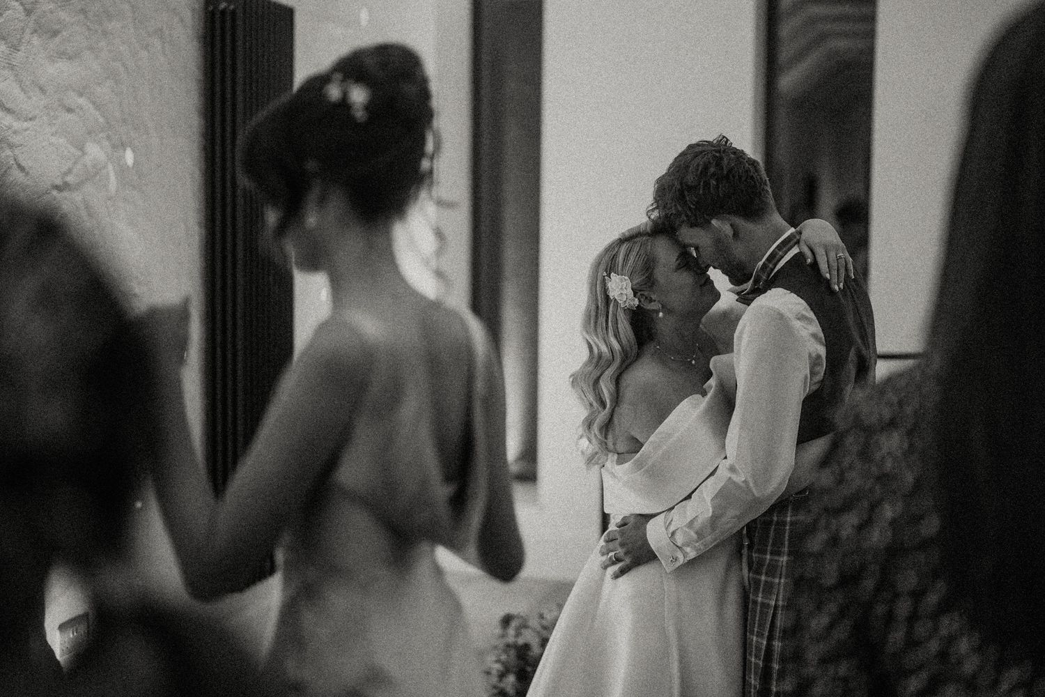 Black and white intimate moment captured during wedding celebration.