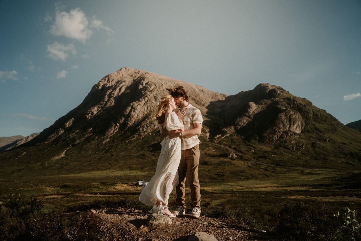 Dramatic mountain vista serves as backdrop for romantic outdoor photography.