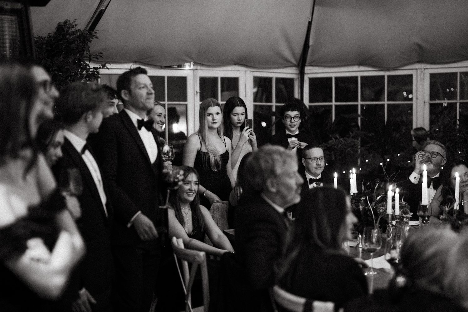 Formal evening reception with guests mingling under ambient lighting and elegant decor.