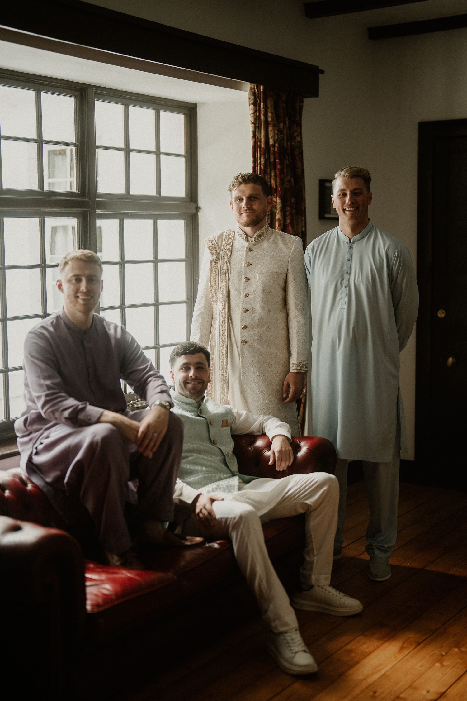 Interior portrait session featuring traditional white and cream colored formal attire.