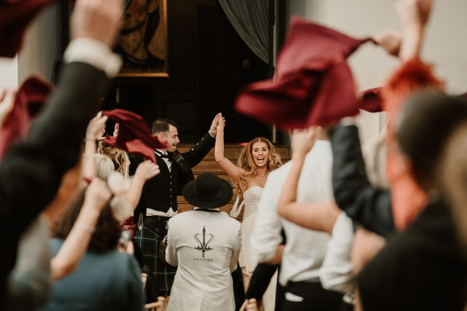 A lively wedding reception dance floor with guests celebrating and dancing.