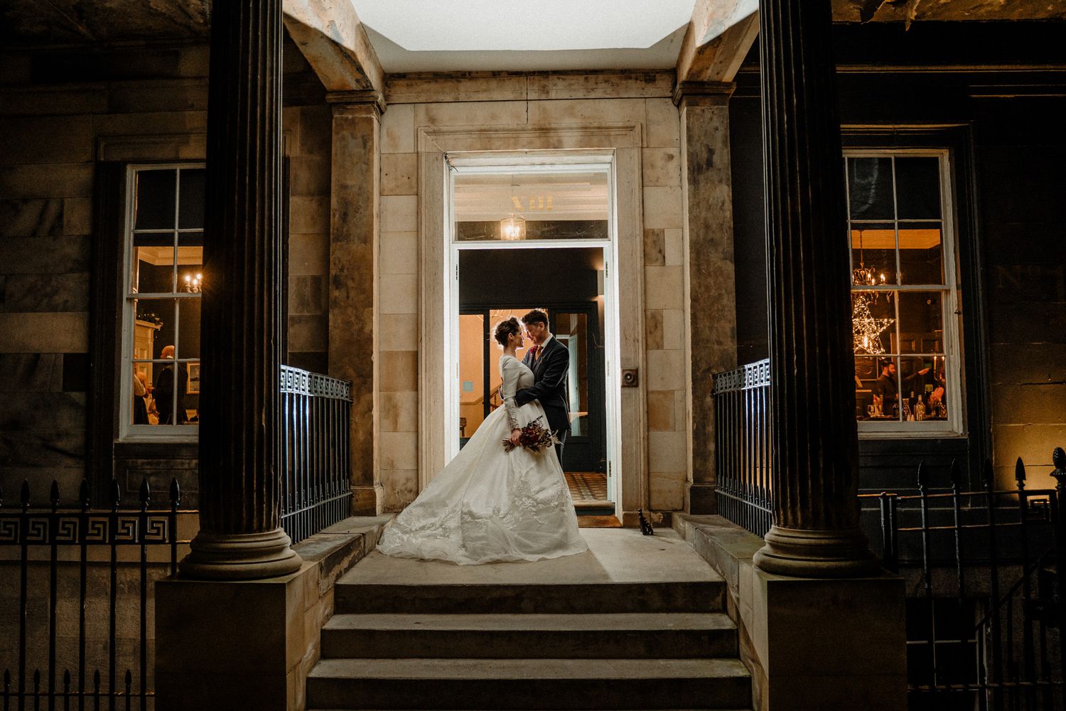 Historic stone building exterior with grand entrance steps and architectural details.
