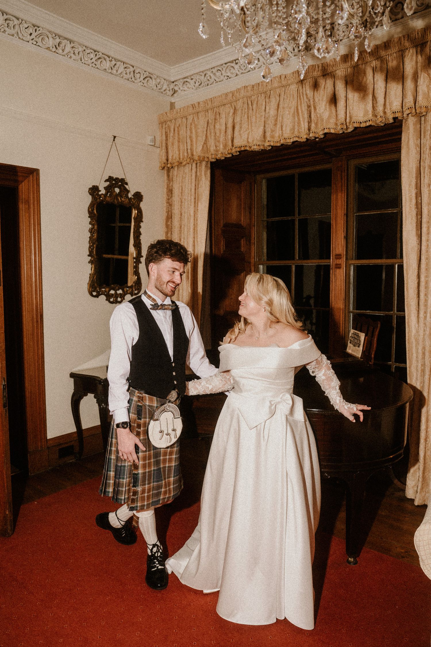 Candid dancing moments captured in a vintage-styled room with elegant curtains and decor.