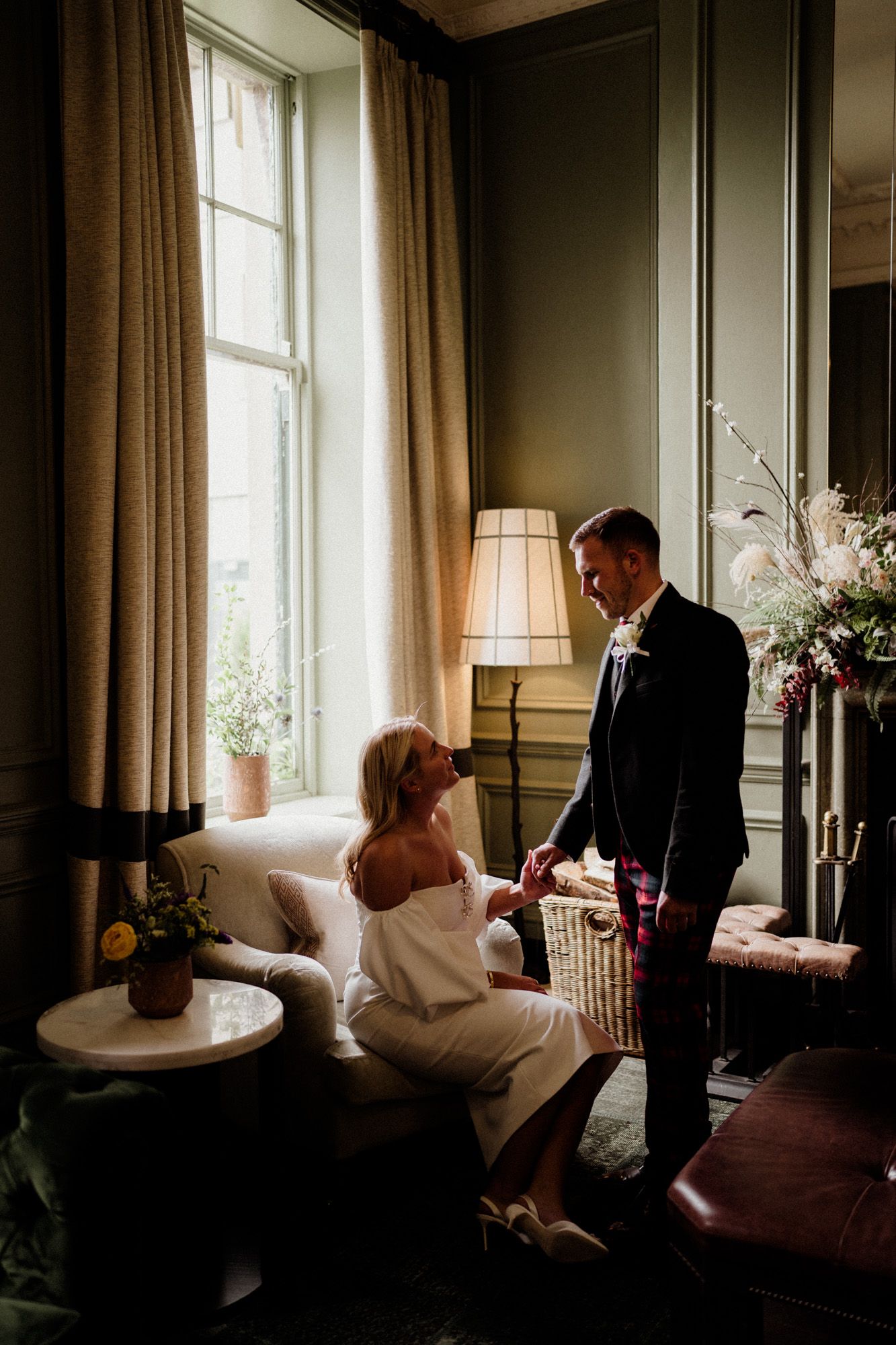 Romantic indoor wedding photos captured in a sunlit room with elegant curtains and decor.