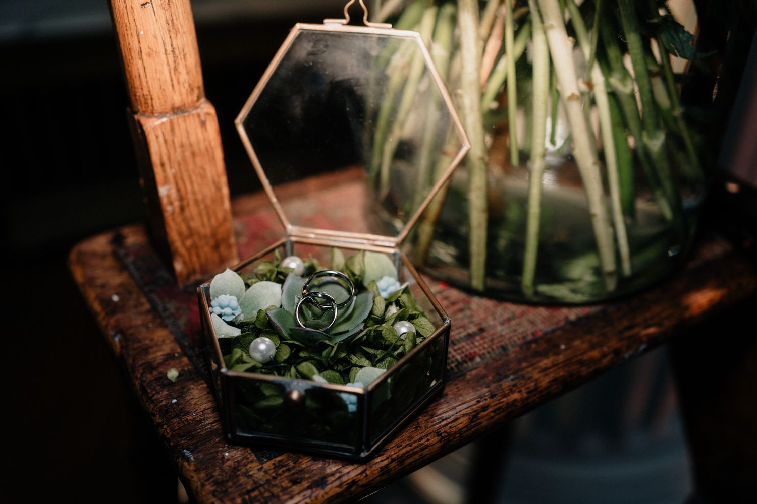 Geometric terrariums with succulents and floral arrangements on rustic wooden surfaces.