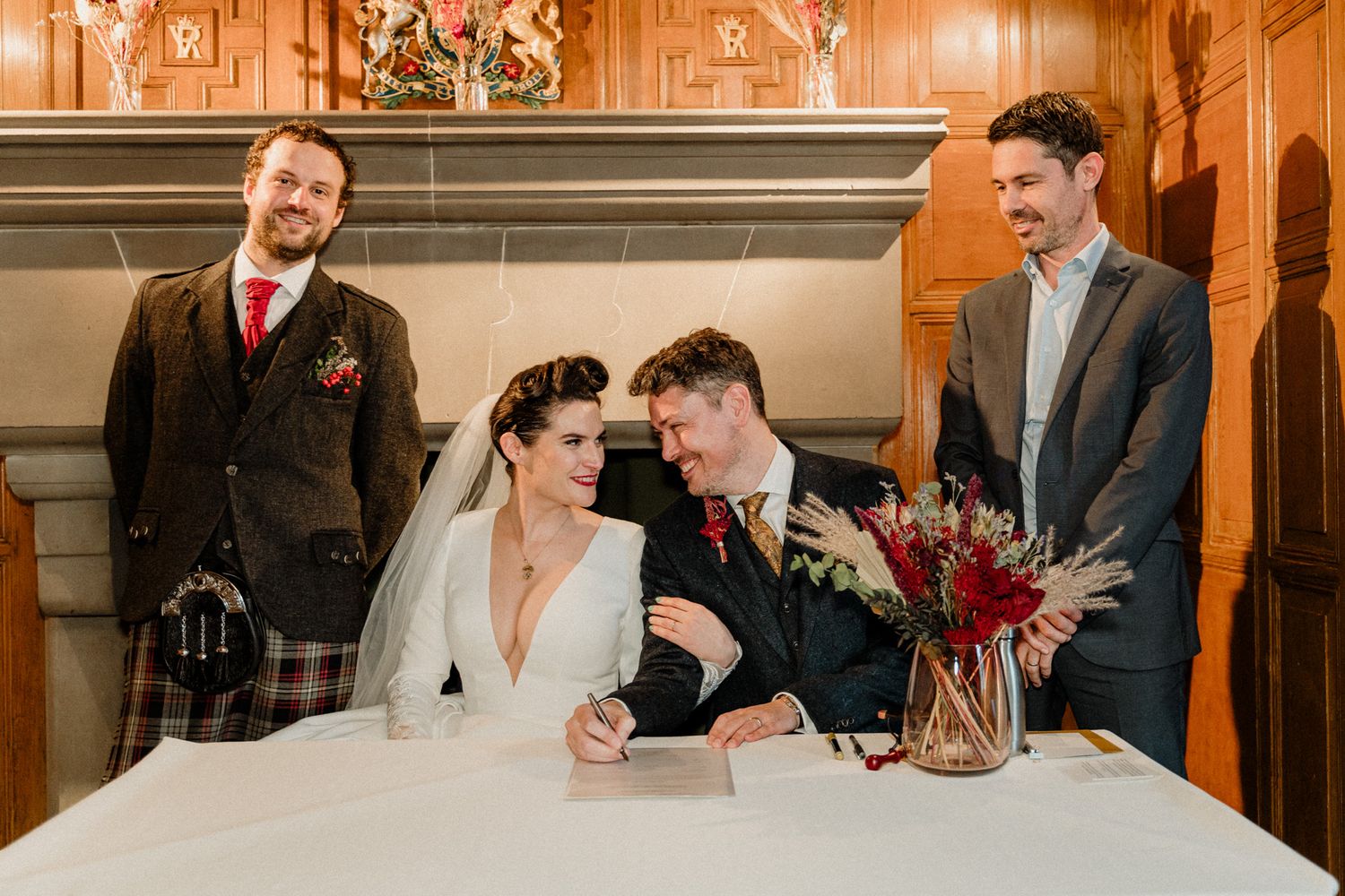 Wedding ceremony moments in a traditional wood-paneled Scottish venue.