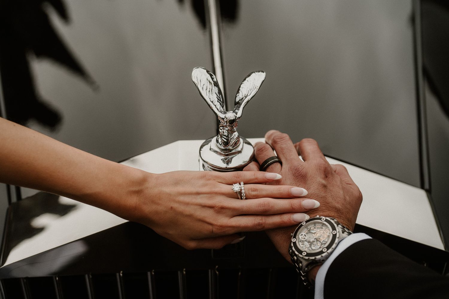 Close-up of hands holding champagne glasses at formal event.