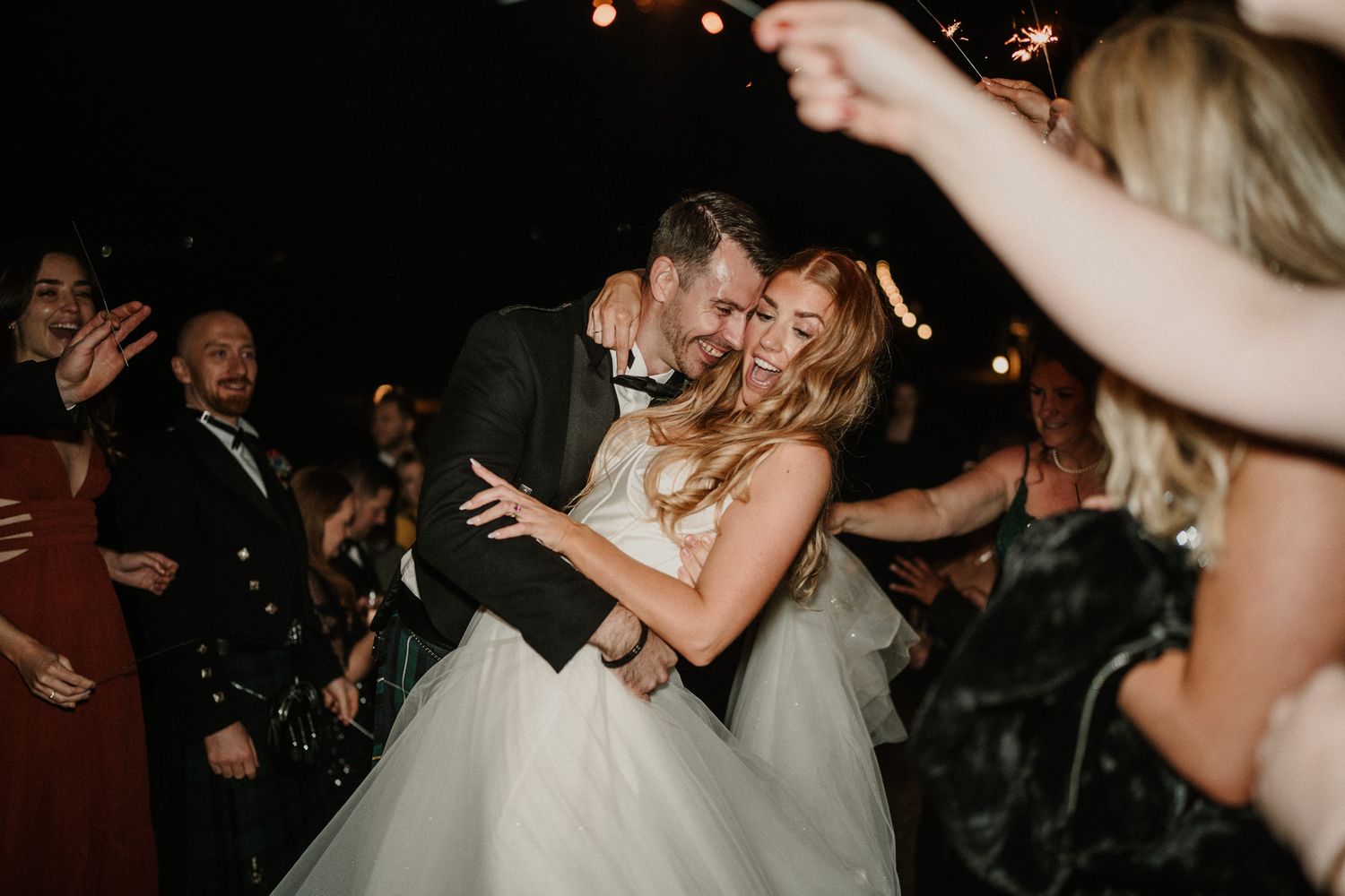 Wedding reception dance floor filled with guests celebrating and dancing.