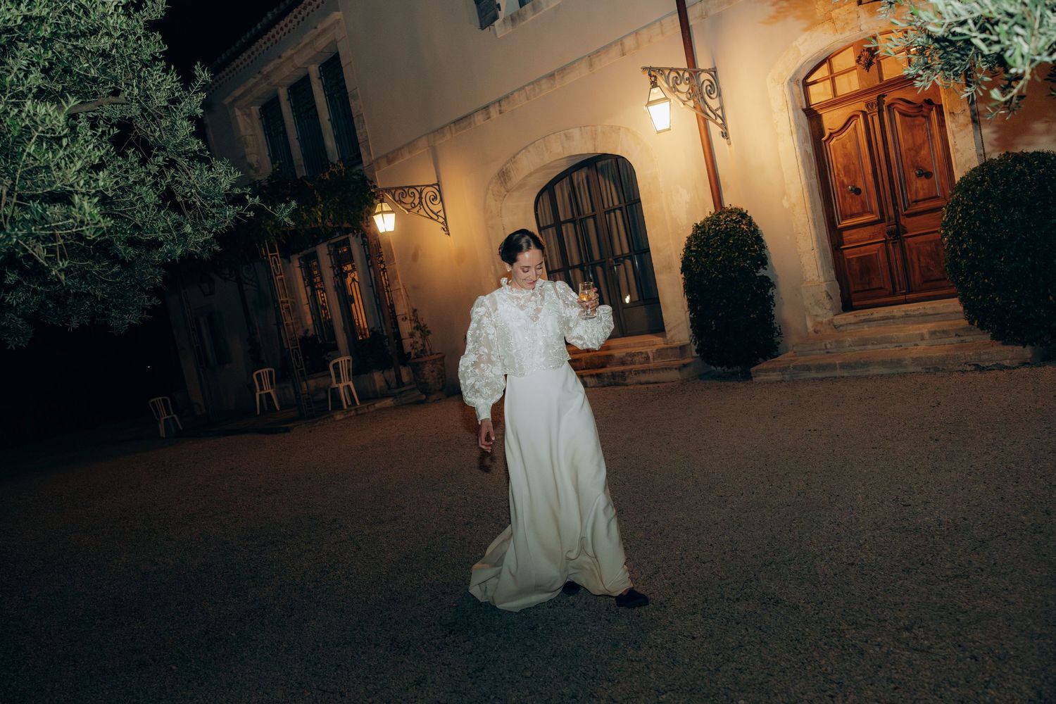 Evening wedding reception scene with warm lighting and outdoor venue.