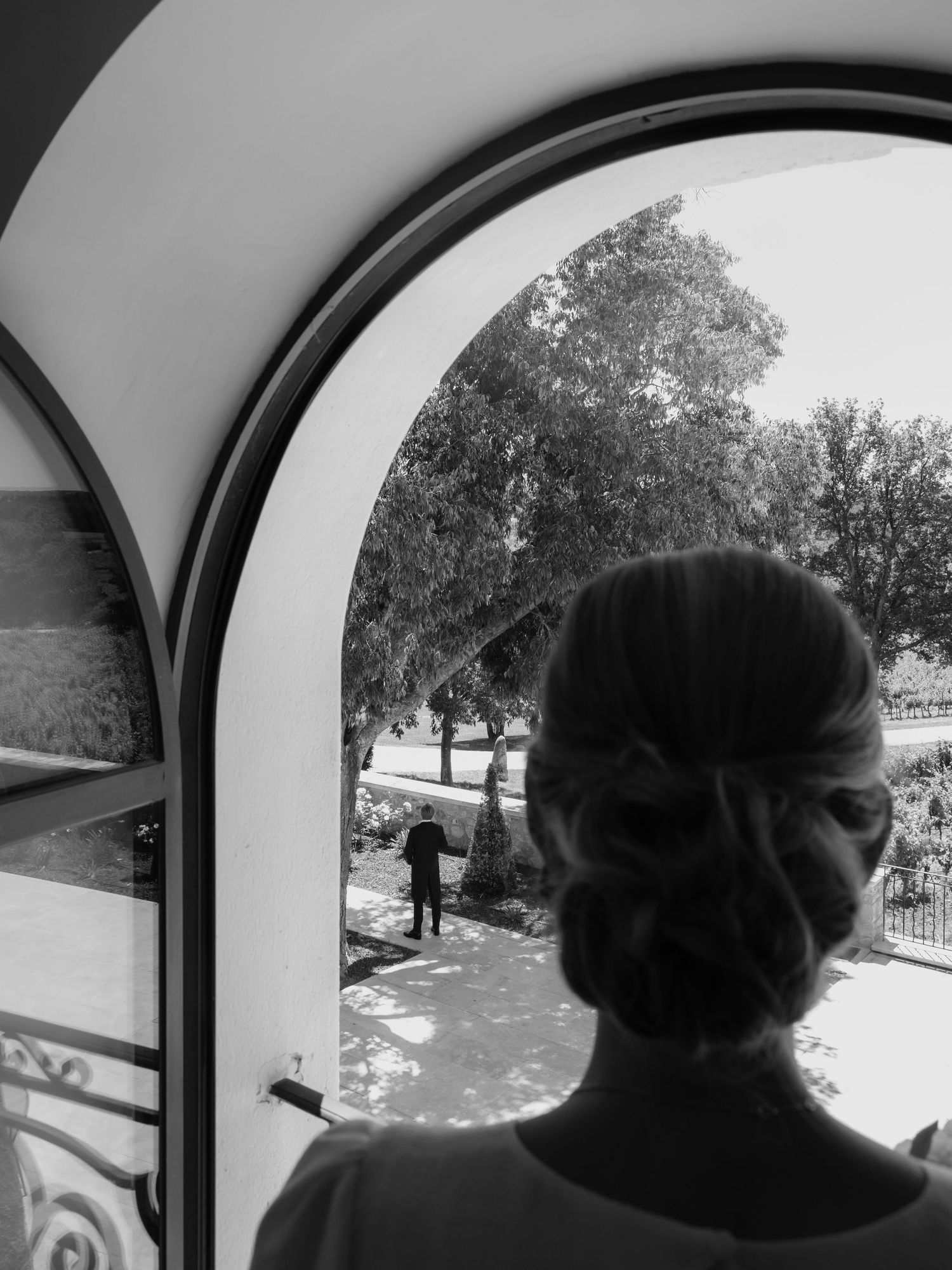 Black and white view through a car window showing a scenic outdoor setting.