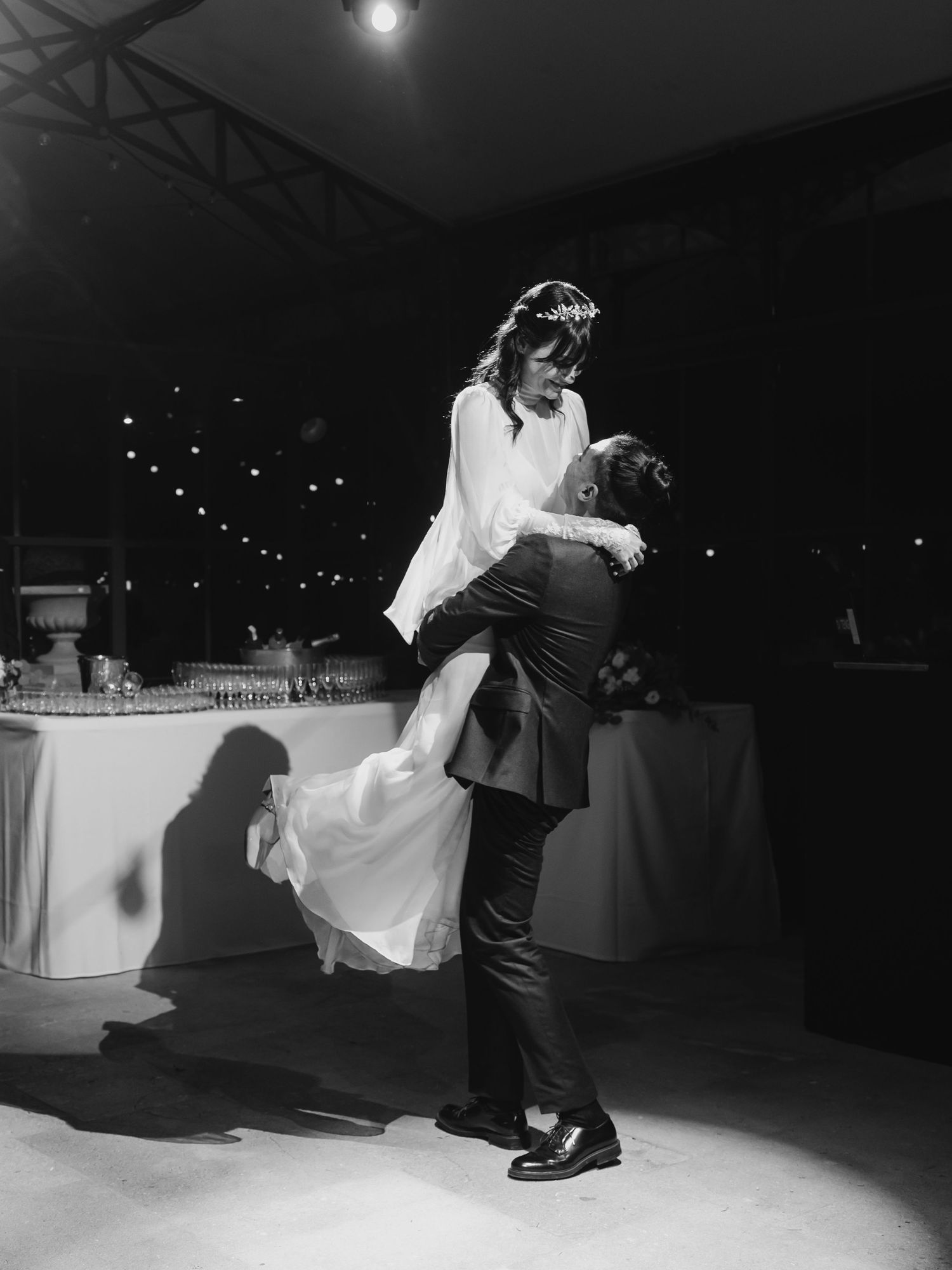 Black and white photo of a couple dancing at their wedding reception.