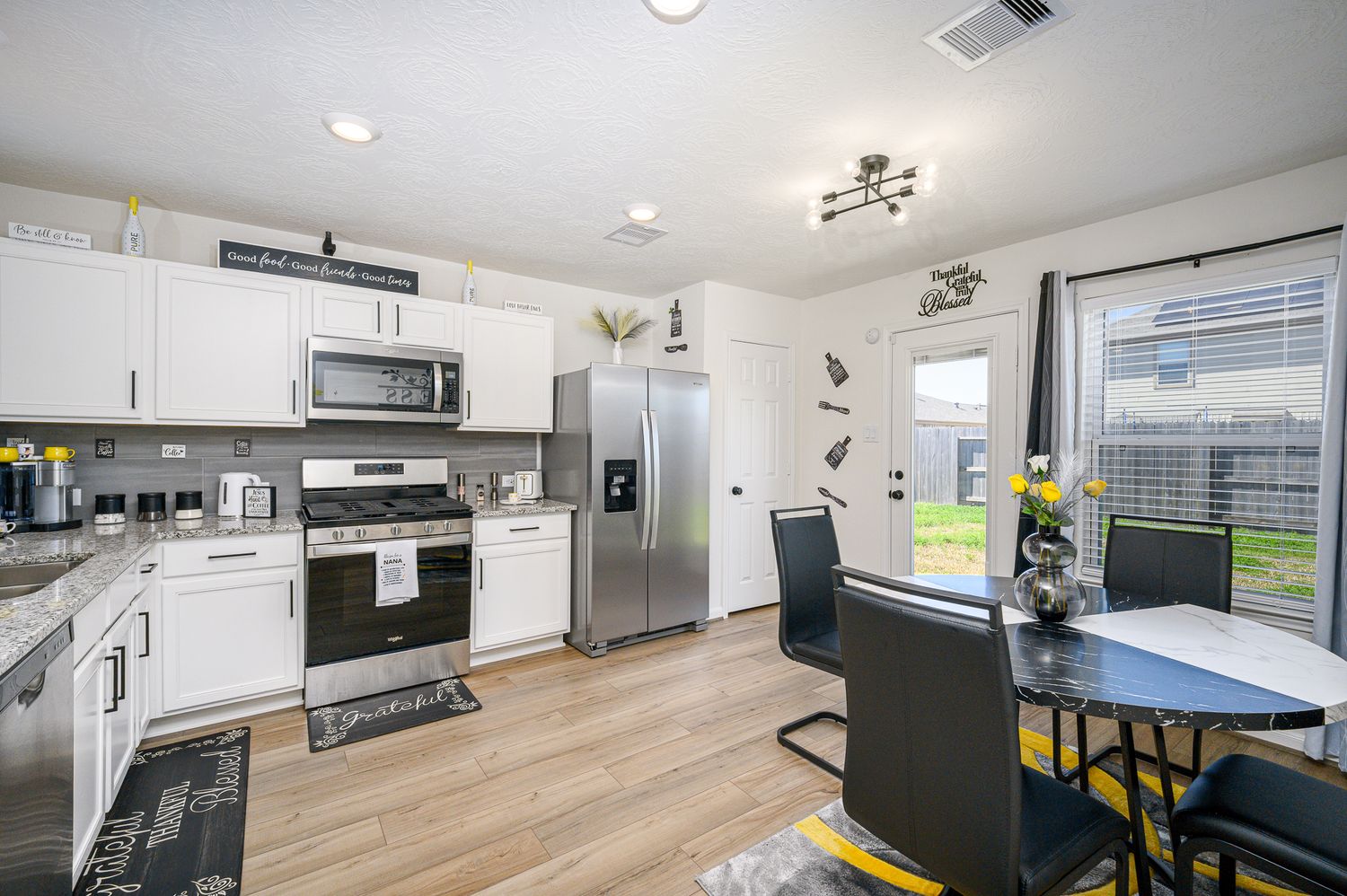 7316 Stella marina way Texas city Texas Modern kitchen with white cabinets, stainless steel appliances, hardwood floors.