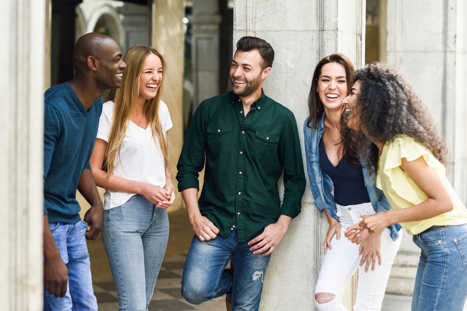 Group of friends laughing together, representing connection, belonging, and positive community engagement.