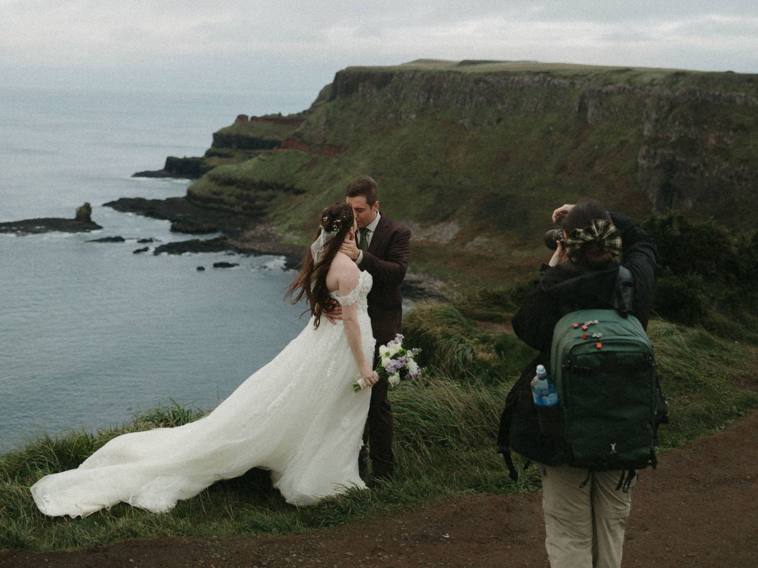 Wedding photography session on dramatic coastal cliffs overlooking the ocean.