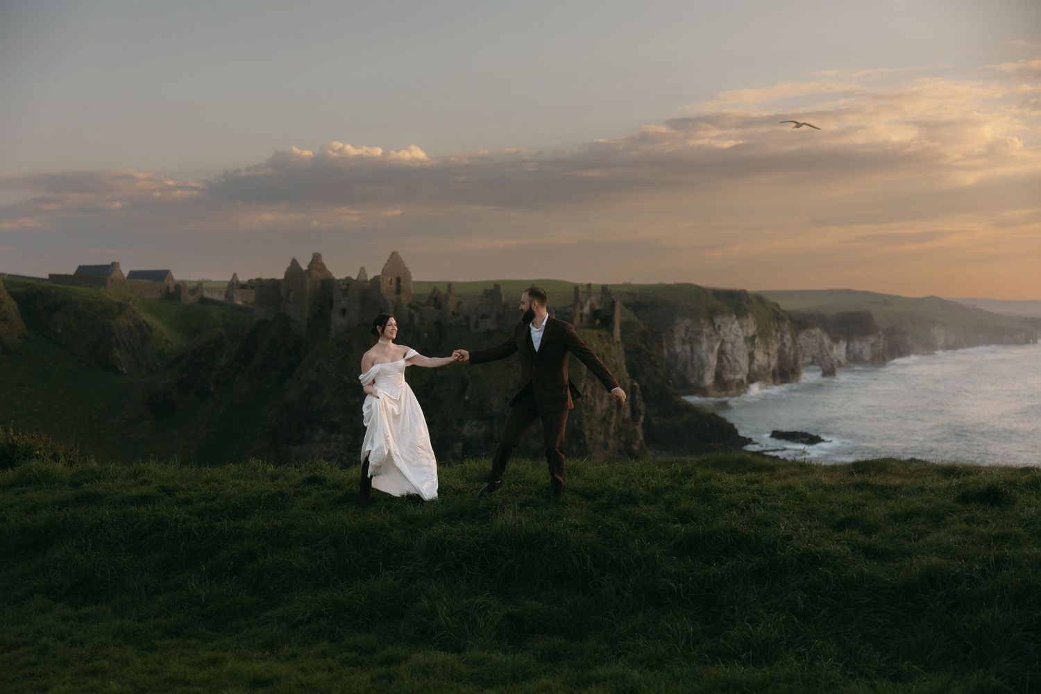Golden hour wedding photos captured on stunning Irish coastal cliffs.
