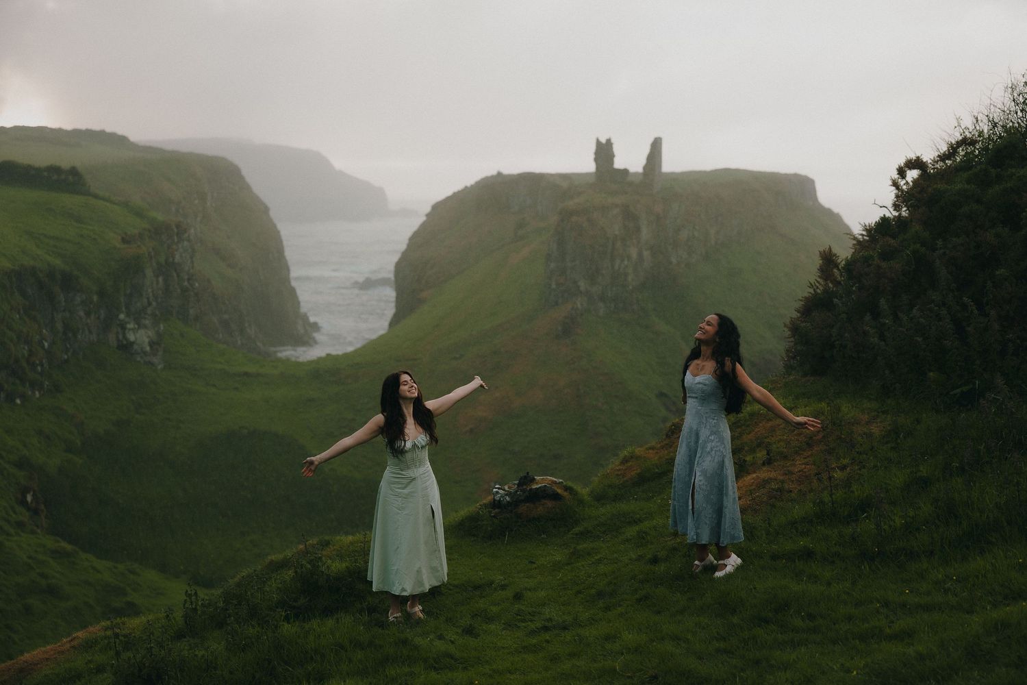 Scenic Irish coastline with green cliffs and figures enjoying the view.