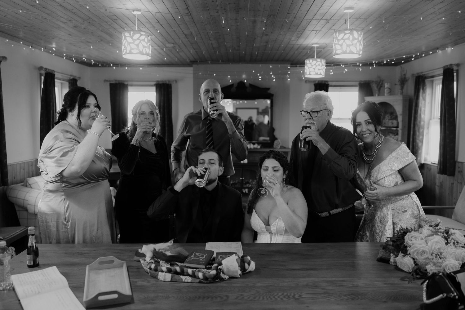 A black and white photo collage showing multiple wedding reception scenes with dancing and celebration moments.