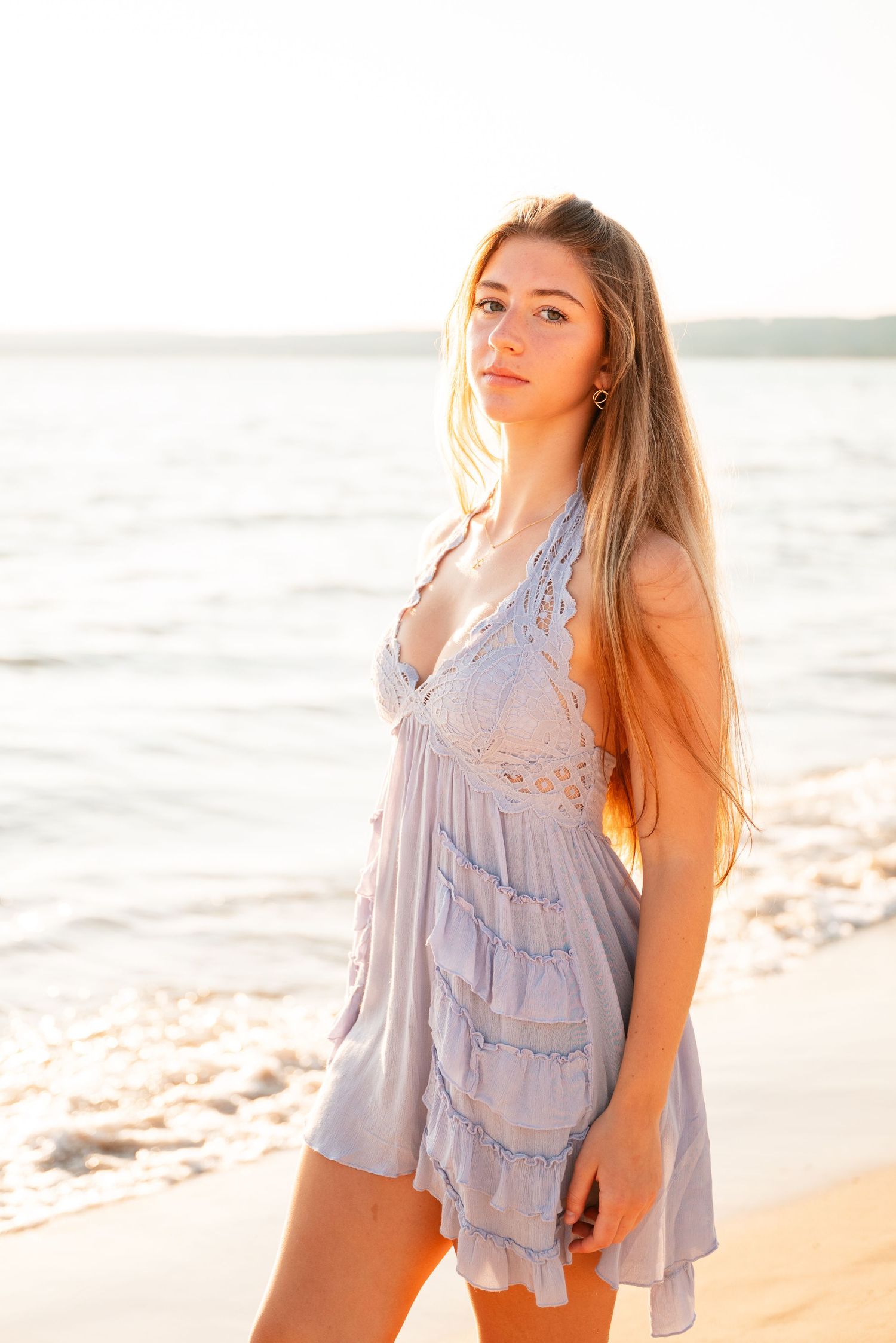 Beach portrait at golden hour wearing a flowy lavender dress.