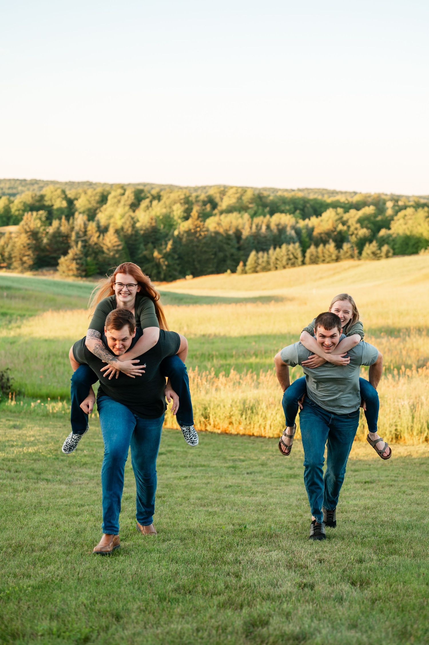 Playful piggyback rides in an open grassy field at golden hour.