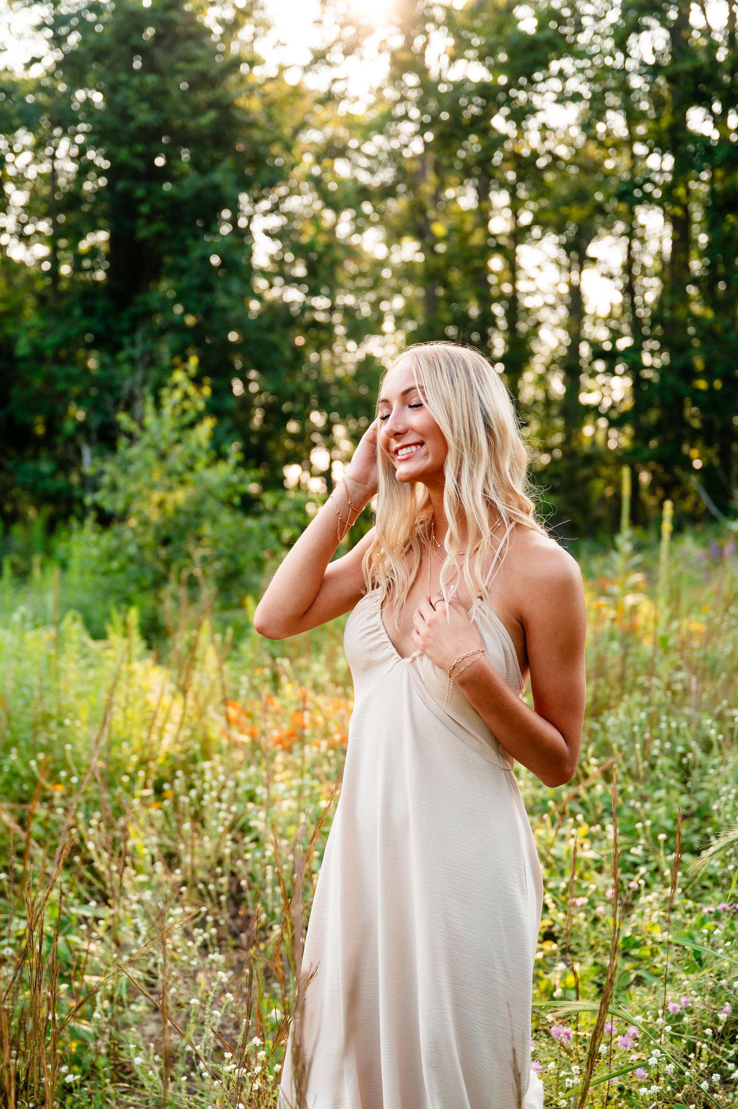 A white flowy dress catches the evening light in a wildflower meadow.