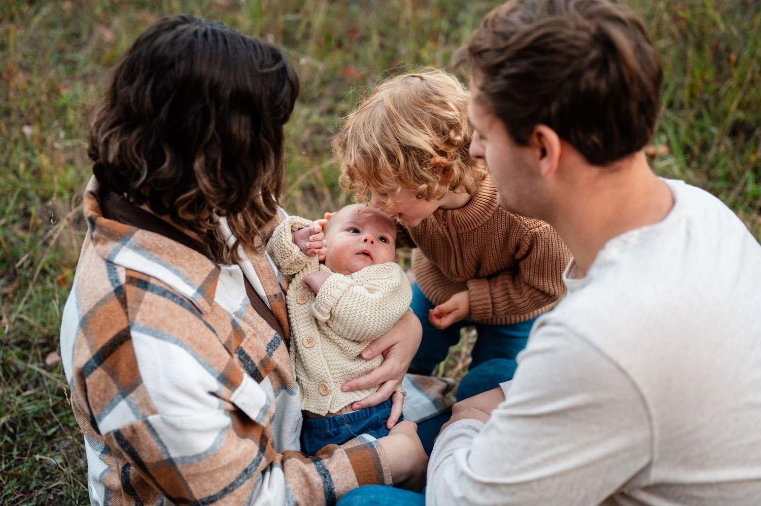 Tender family interaction photographed in outdoor setting.