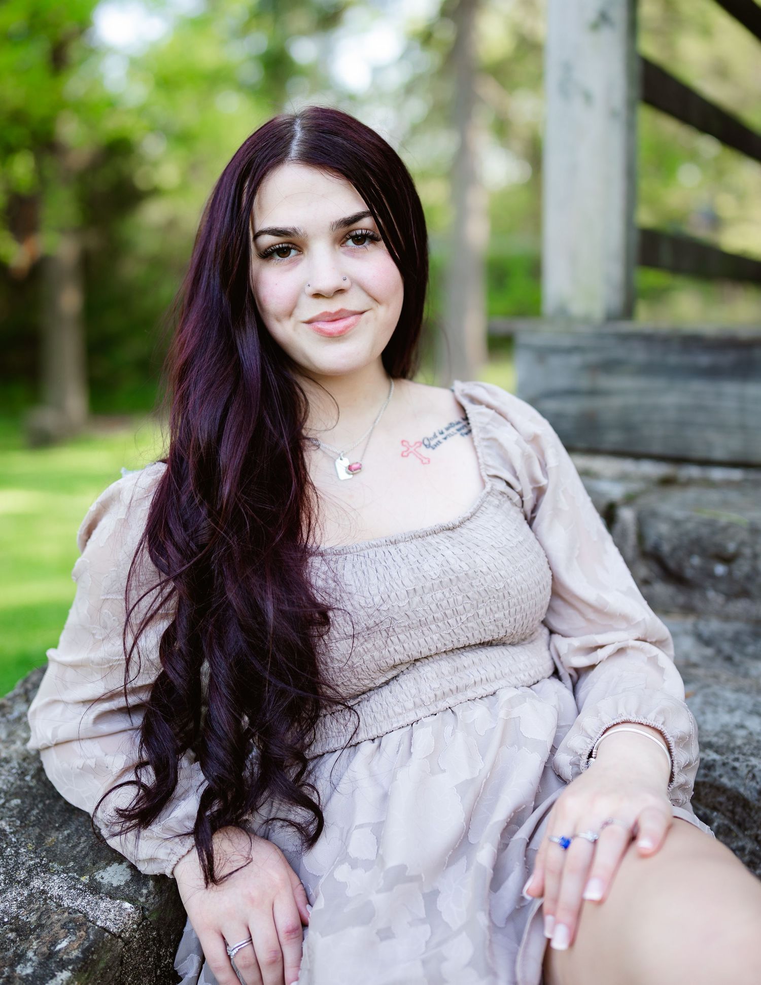 Portrait series in vintage-style dress against rustic wooden backdrop outdoors.