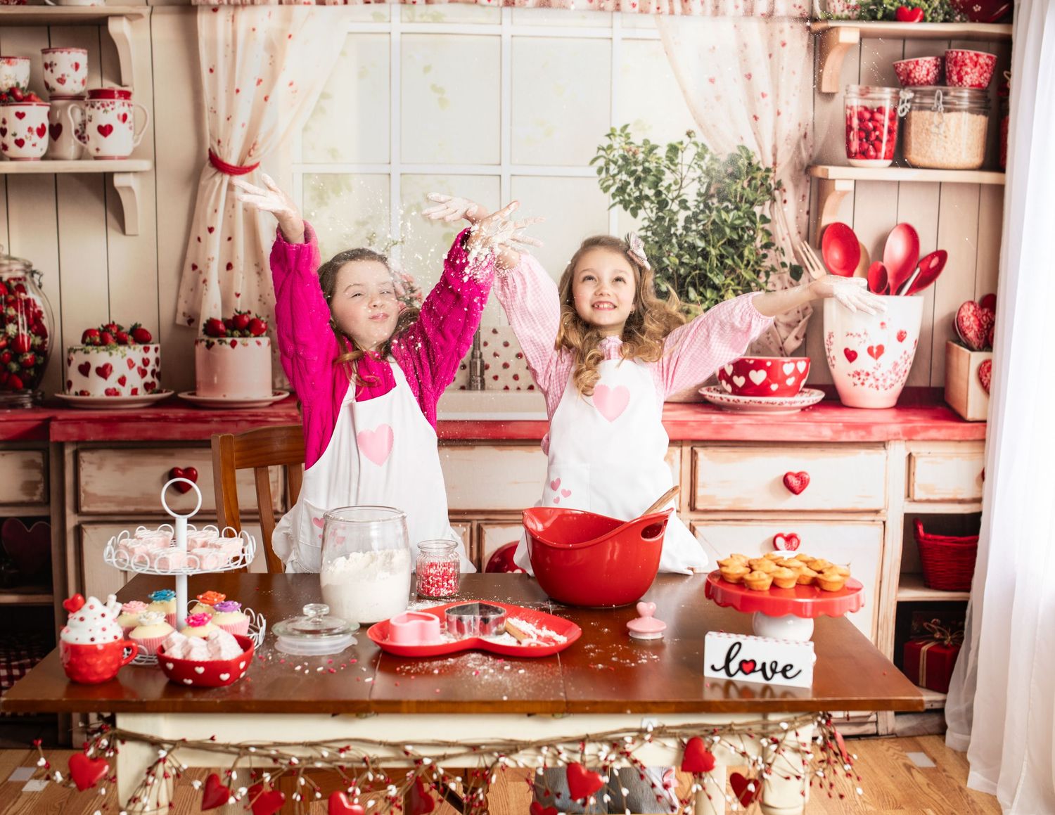 A romantic Valentine's Day party setup with red and pink decorations, hearts, and festive table settings.