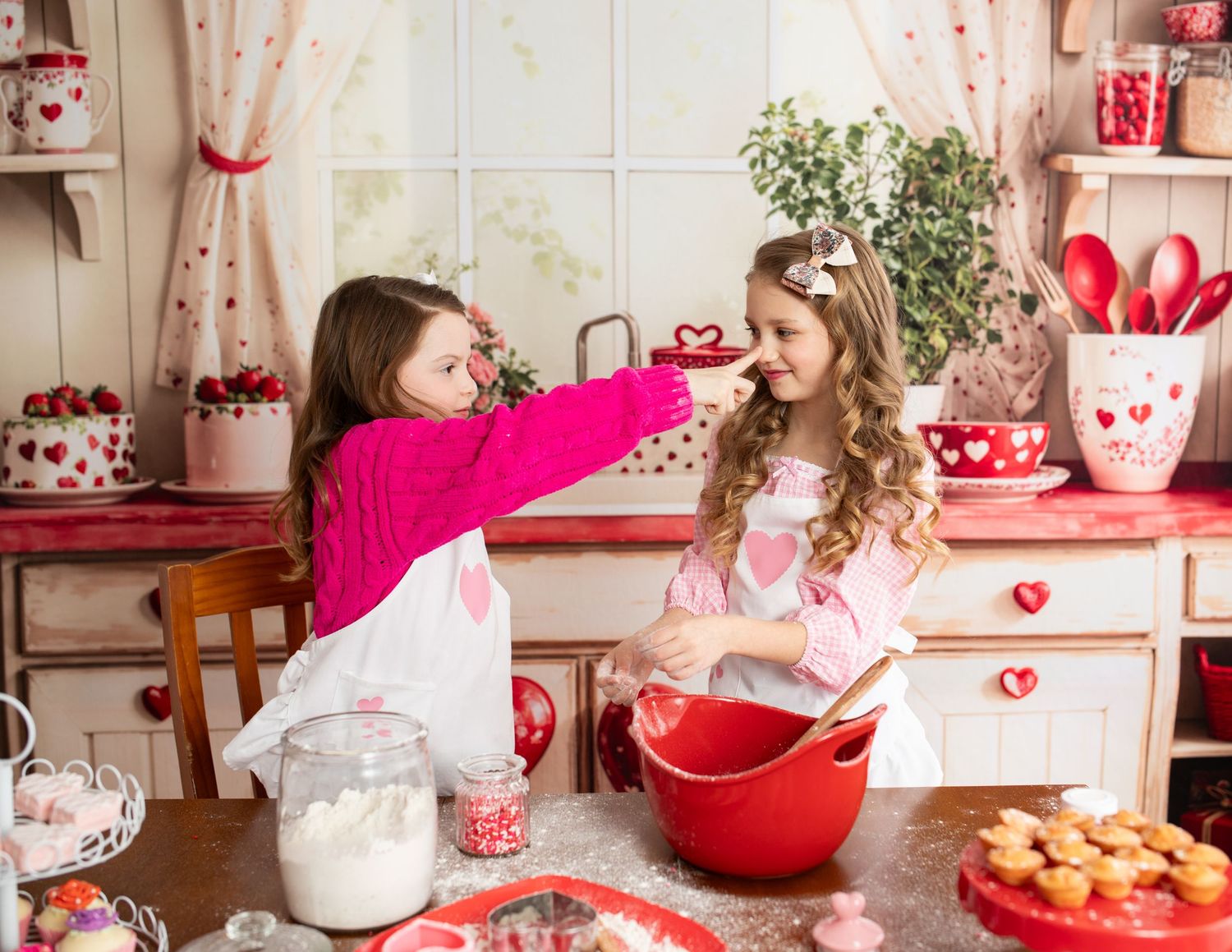 Red and pink Valentine's Day kitchen setup with heart decorations and baked treats.