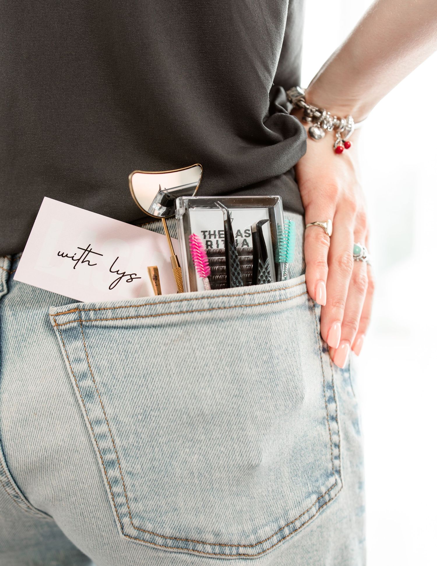 Close-up of denim pocket filled with colorful pens and markers.