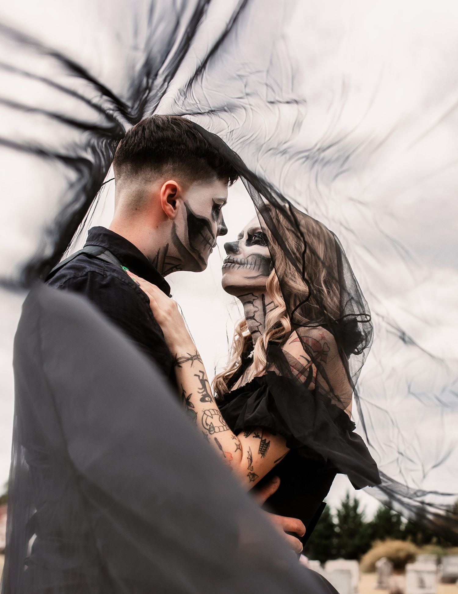 Dramatic black and white portrait with flowing dark veils.
