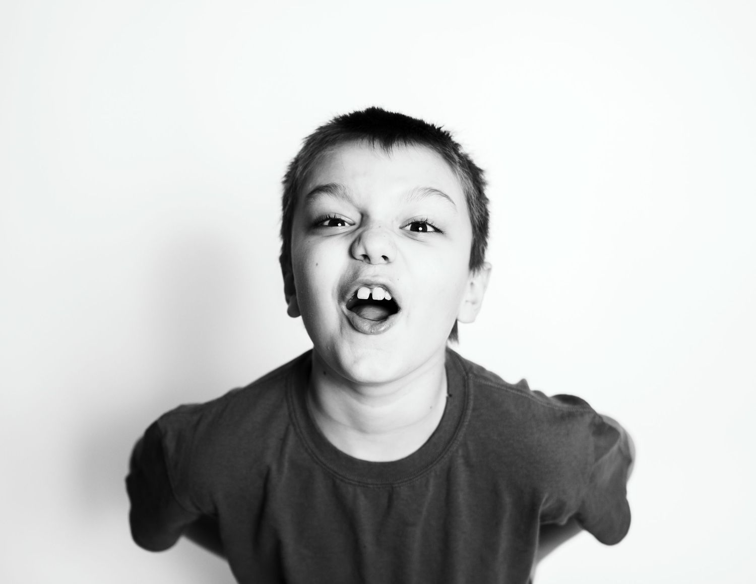 A black and white portrait showing an energetic expression and animated pose.